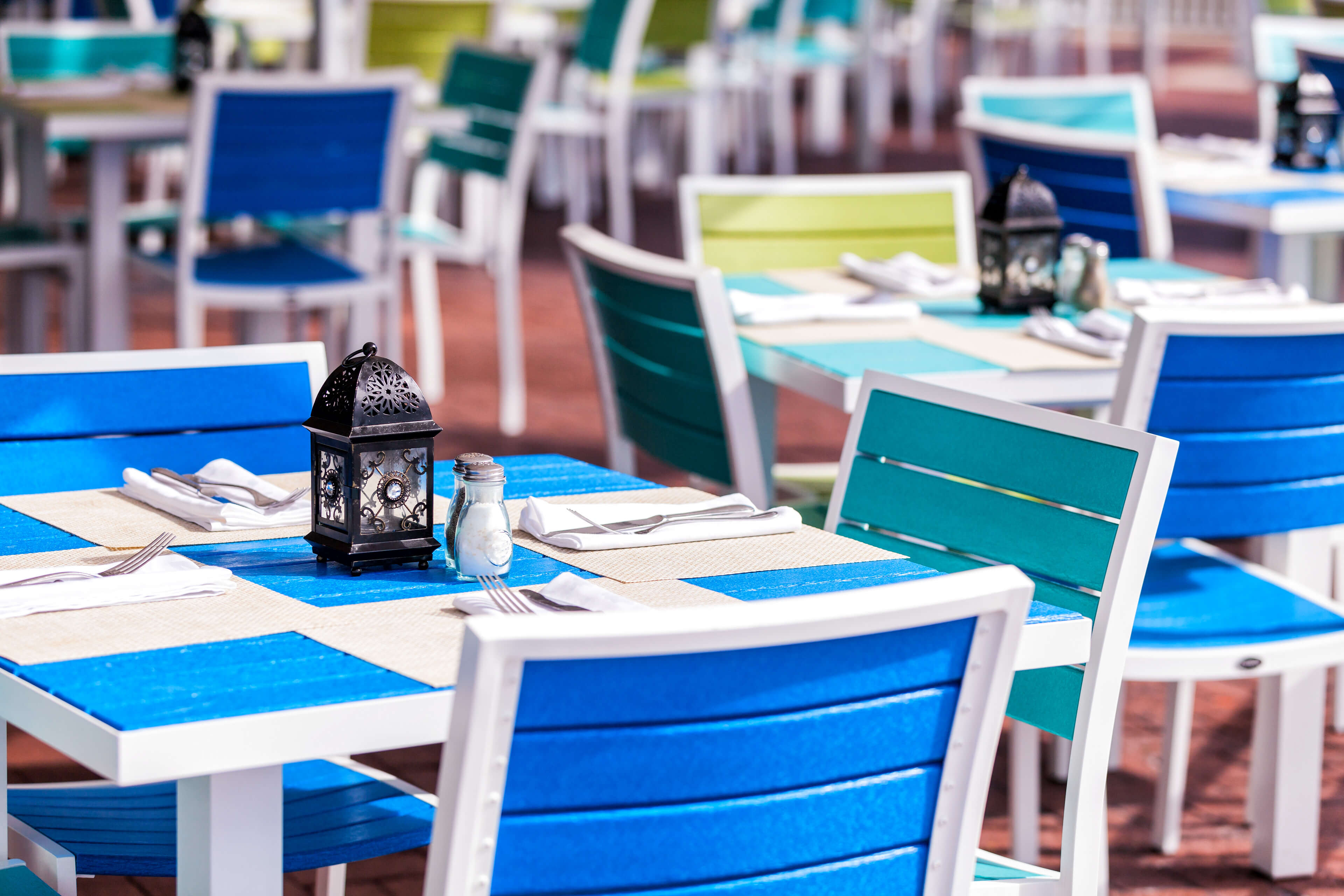 Table with cutlery and blue chairs